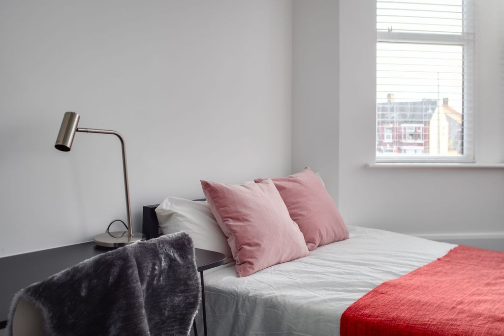 Property photo 3 of 7 A Modern, Neatly Made Bedroom Featuring A Comforta...