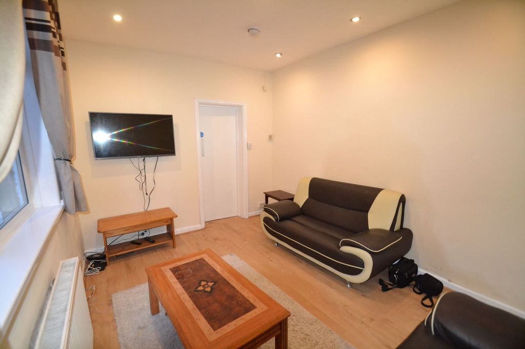 Property photo 3 of 27 A Welcoming Living Room Featuring A Modern Dark So...