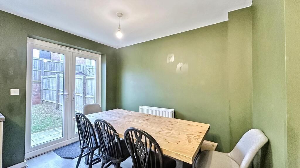Property photo 3 of 7 Bright Dining Area With A Large Wooden Table And S...