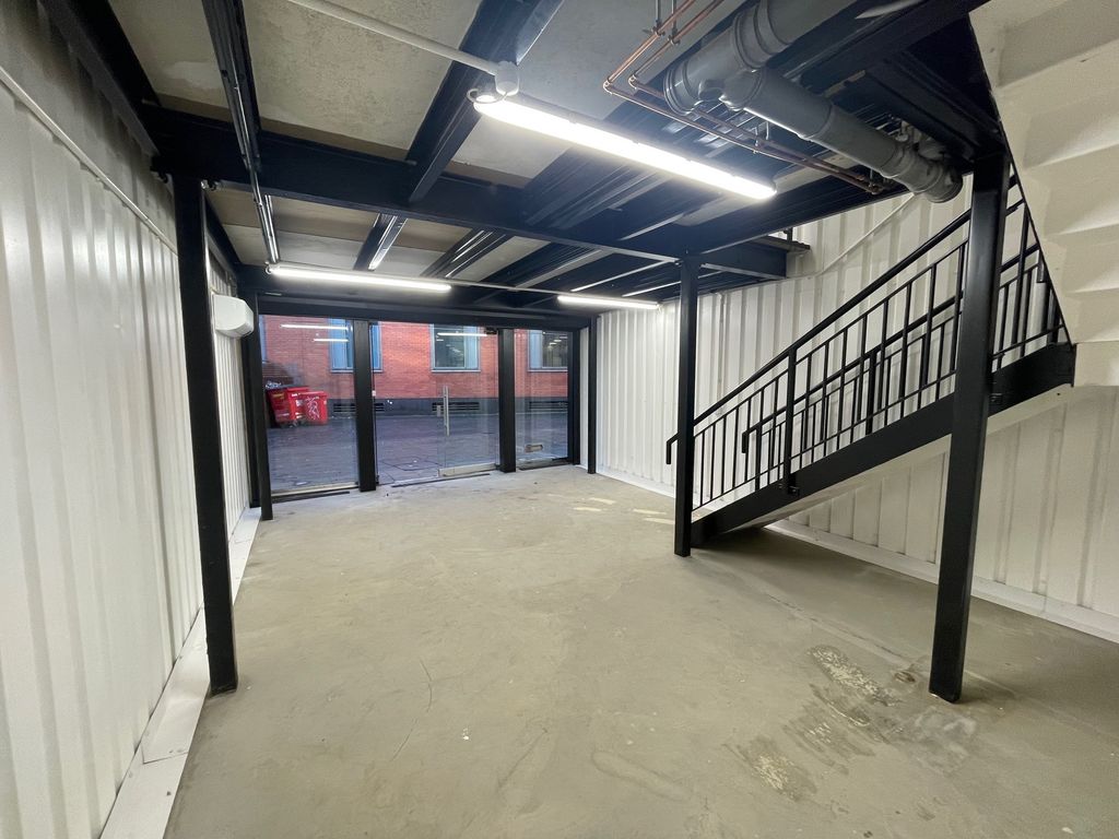 Property photo 2 of 4 An Arch With White Lining And A Ground Floor Level And A Mezzanine Level, Connected By Stairs.