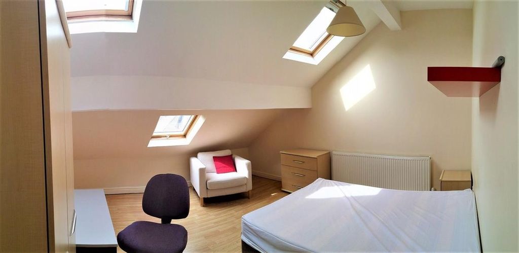 Property photo 3 of 12 Bright And Spacious Attic Bedroom Featuring A Comf...
