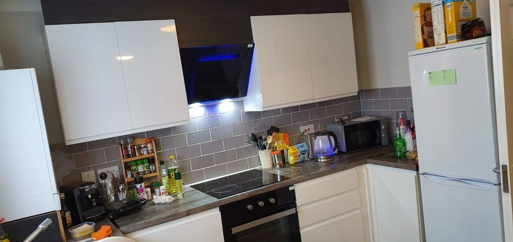Property photo 1 of 10 This Modern Kitchen Features Sleek Cabinetry And A...
