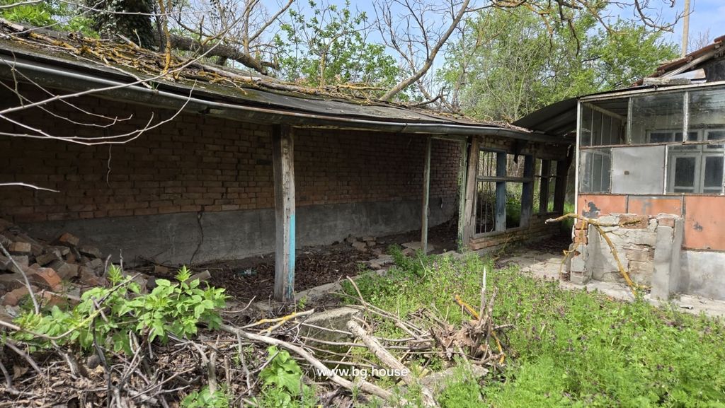 Property photo 2 of 66 Brick Outbuilding With Wooden Supports And Glass Porch Adjacent To The House, Surrounded By Overgrown Vegetation