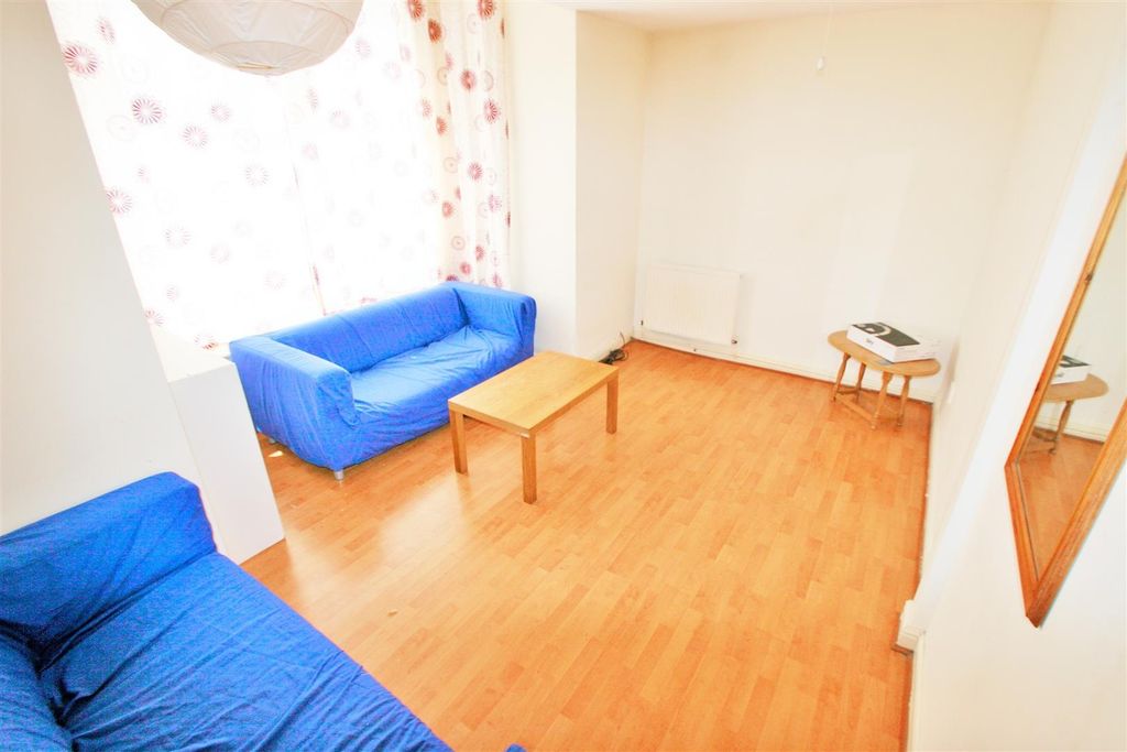 Property photo 2 of 6 Bright And Inviting Living Room Featuring Two Comf...