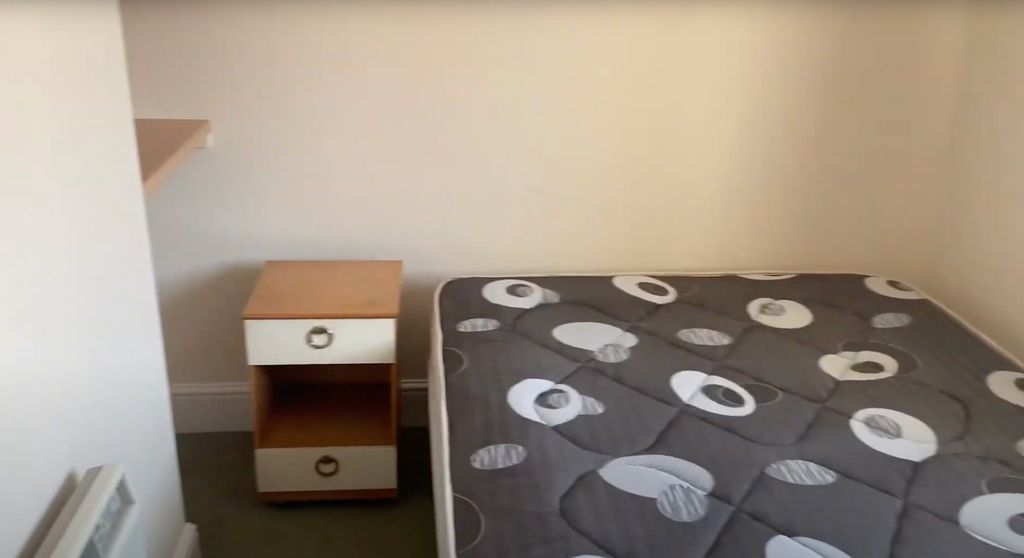 Property photo 1 of 4 A Cozy Bedroom Featuring A Neatly Made Bed With A ...