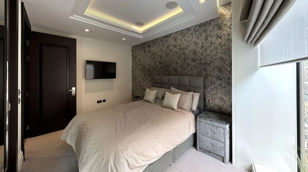 Property photo 3 of 24 A Stylish Master Bedroom Featuring A Comfortable d...