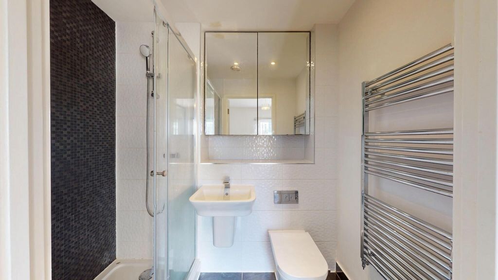 Property photo 3 of 14 Bright And Modern Bathroom Featuring A Sleek Showe...