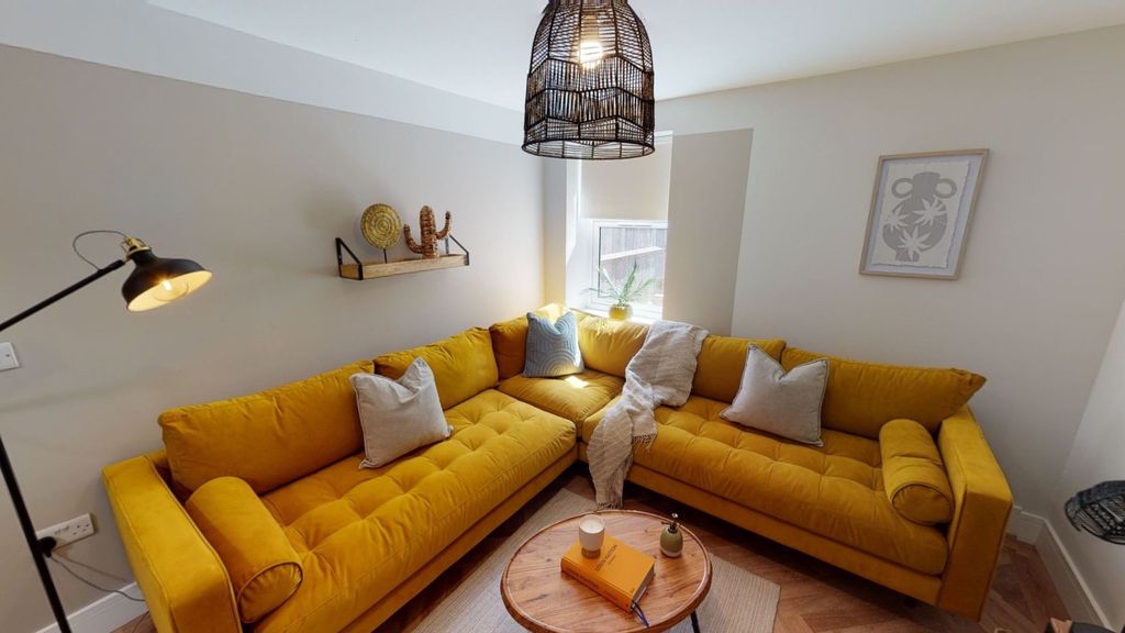 Property photo 1 of 8 Bright And Stylish Living Room Featuring A Vibrant...