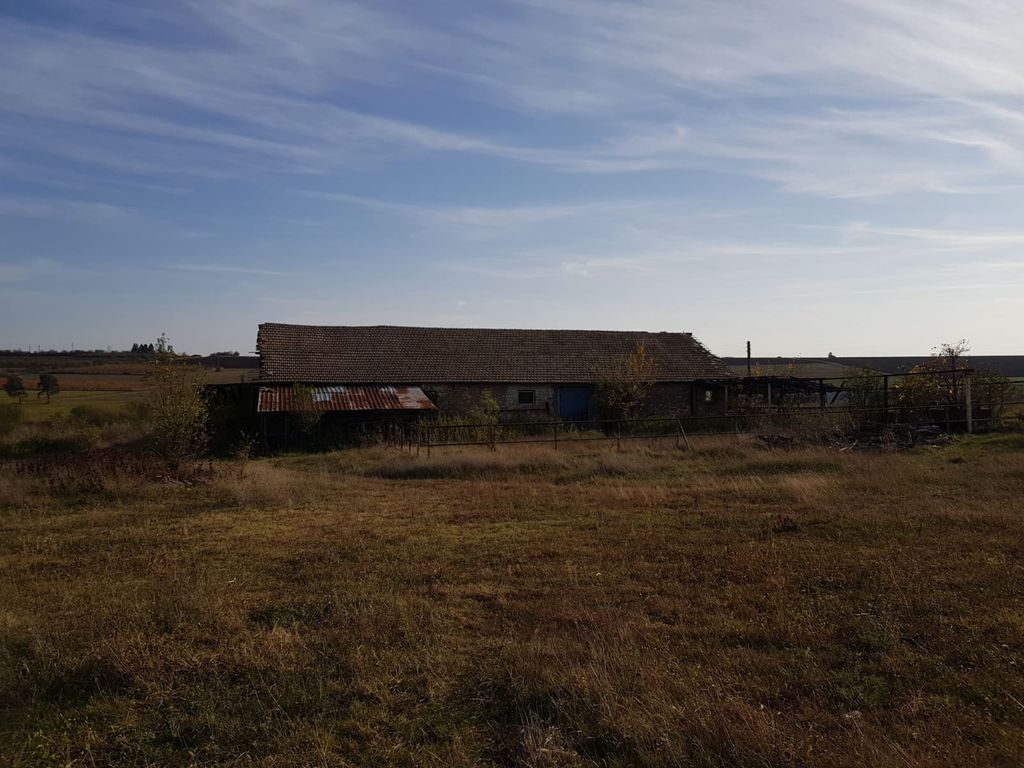 Property photo 2 of 33 Wide View Of The Farm Building With Tiled Roof And Metal Fencing, Set In Open Grassy Land Under A Partly Cloudy Sky.