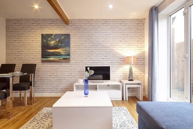 Property photo 2 of 12 Bright And Stylish Living Room Featuring Modern De...