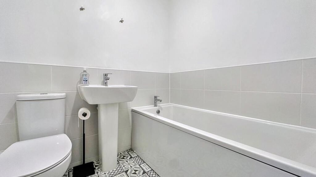 Property photo 2 of 7 Bright, Modern Bathroom With A White Suite, Bathtu...