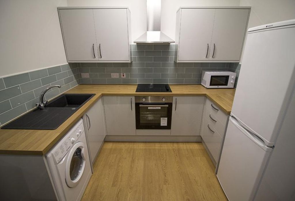 Property photo 3 of 5 This Modern Kitchen Features Sleek Cabinetry, Ampl...