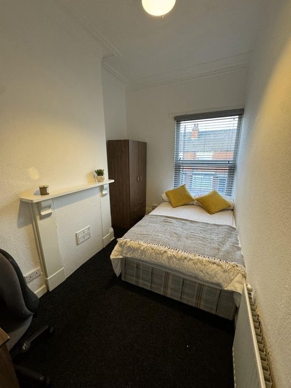 Property photo 2 of 14 A Neat And Cozy Bedroom Featuring A Comfortable Si...