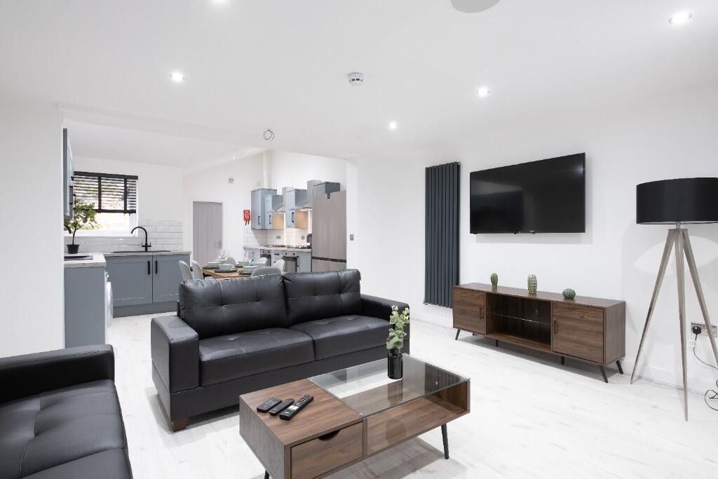 Property photo 2 of 11 A Modern And Spacious Living Room With Sleek Black...