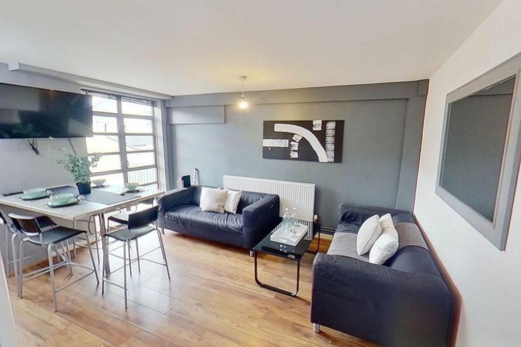 Property photo 2 of 8 This Inviting Living Room Features Modern Furnishi...