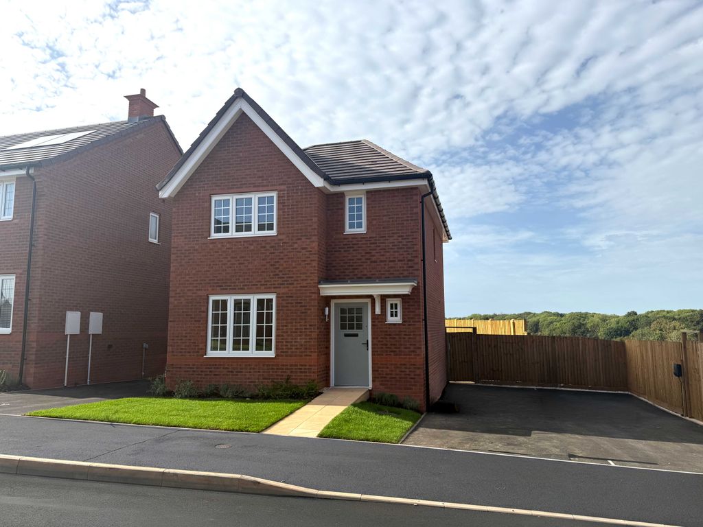Property photo 1 of 9 A Modern Red Brick House With A Neat Lawn In The Foreground Sits Before A Wooden Fence And A Treelin