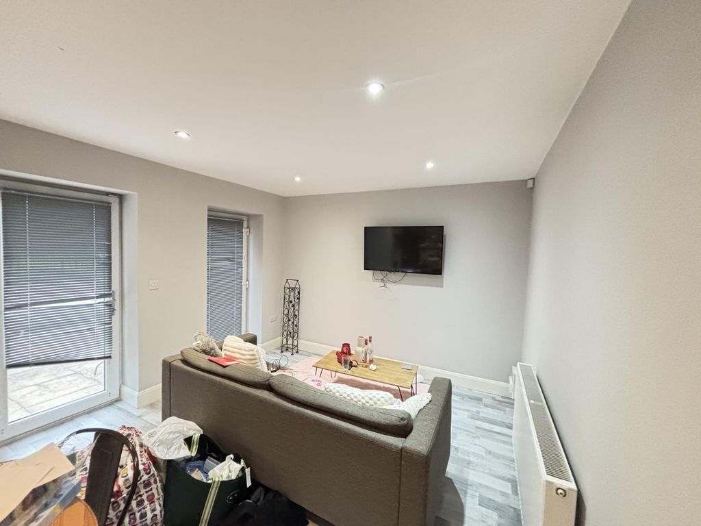 Property photo 3 of 9 A Modern, Well-Lit Living Room Featuring A Comfort...