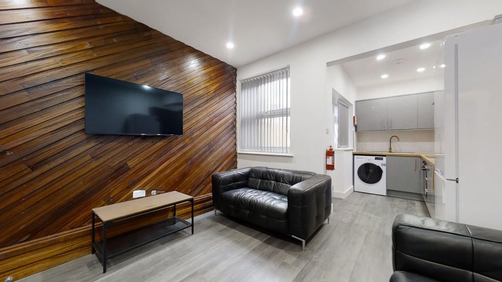 Property photo 2 of 11 A Modern Living Room Featuring Stylish Dark Leathe...