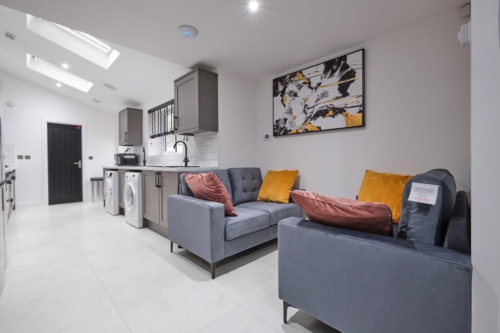 Property photo 2 of 12 Bright And Modern Living Room Featuring Comfortabl...