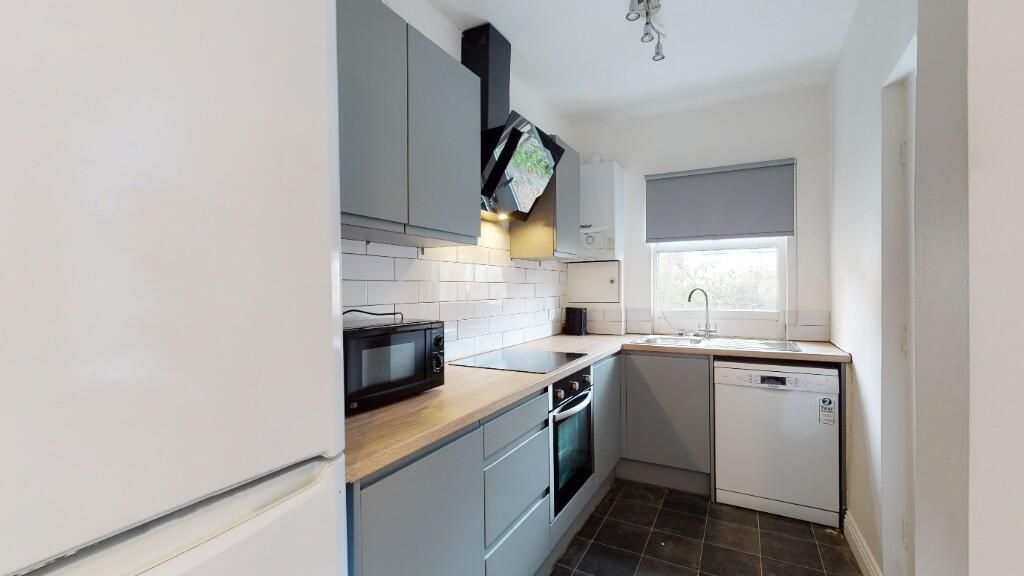 Property photo 3 of 5 A Modern Kitchen With Grey Cabinetry, Wooden Count...