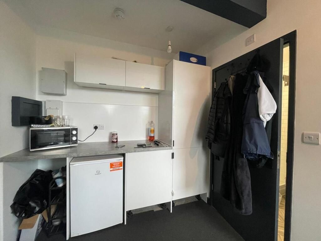 Property photo 3 of 3 A Compact Kitchen With White Cabinets And Some App...