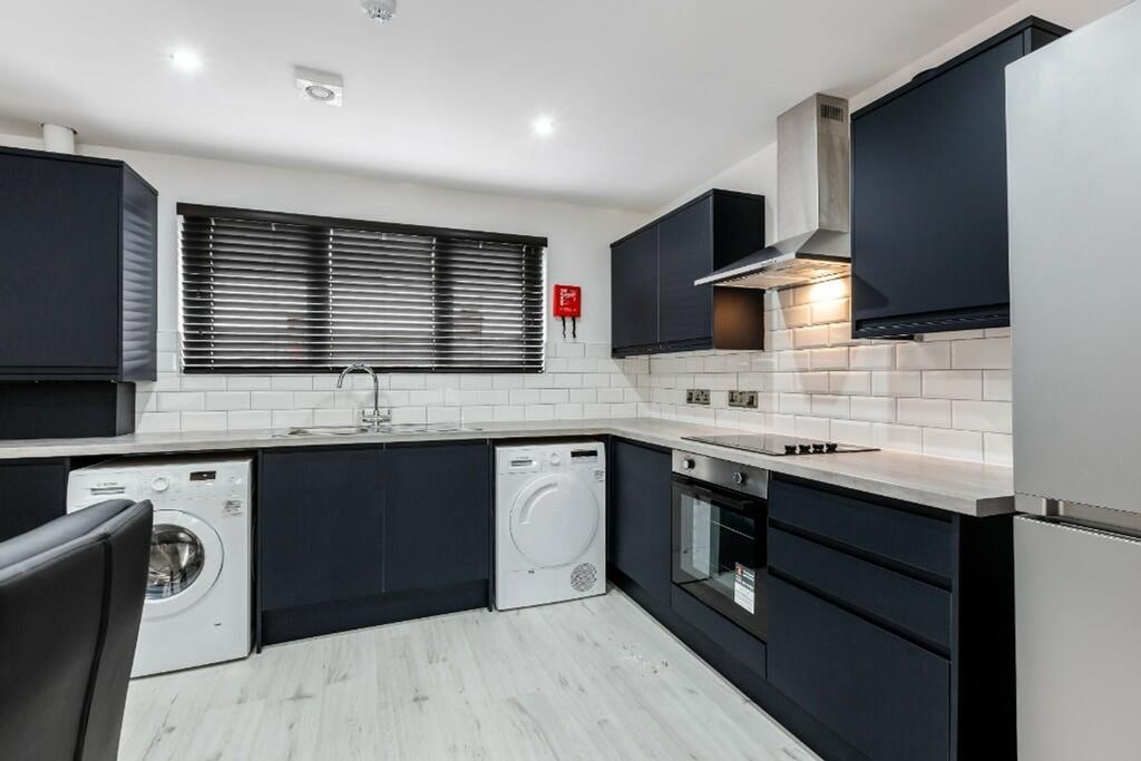 Property photo 1 of 14 Modern Kitchen Featuring Sleek Cabinetry, Ample Co...