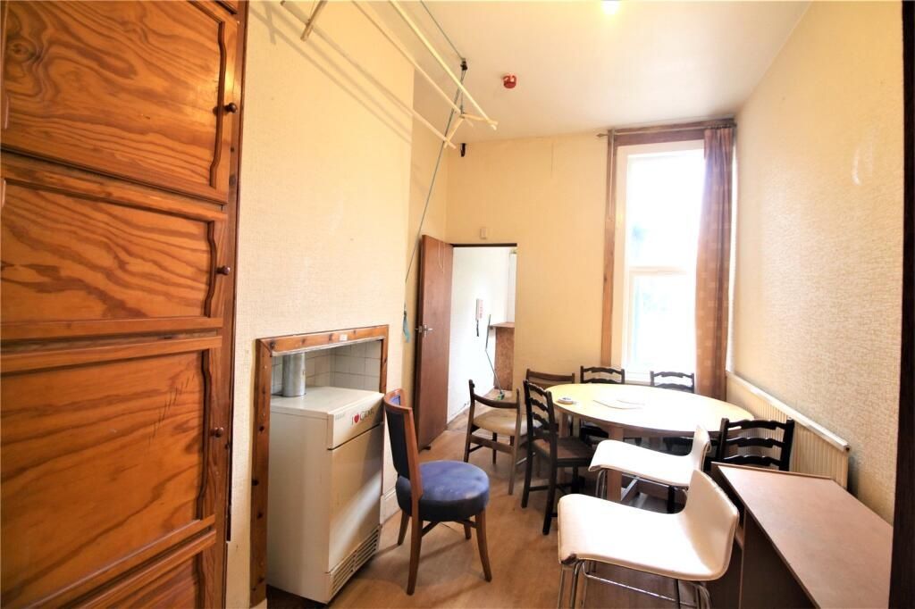 Property photo 2 of 16 A Cozy Single Bedroom Featuring A Tall Window That...