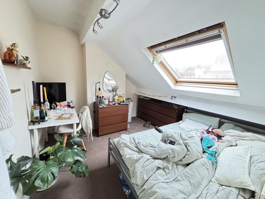 Property photo 2 of 12 A Cozy Bedroom With A Sloped Ceiling Featuring A l...