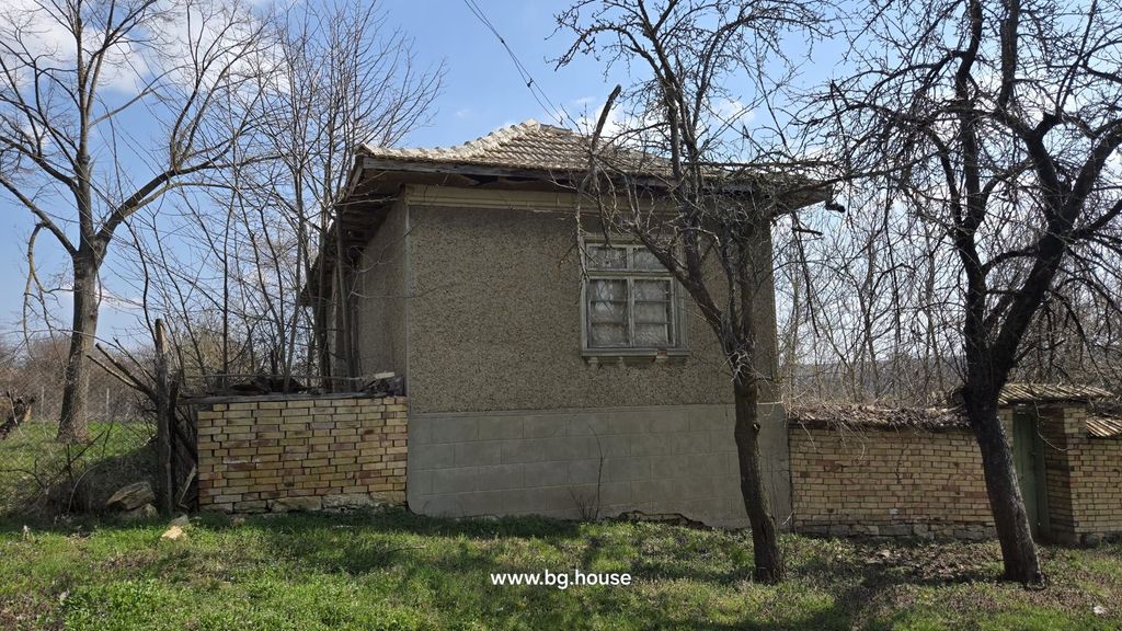 Property photo 2 of 57 Side Perspective Of The House Showing A Tiled Roof, A Window, And A Brick Fence With Leafless Trees Around.