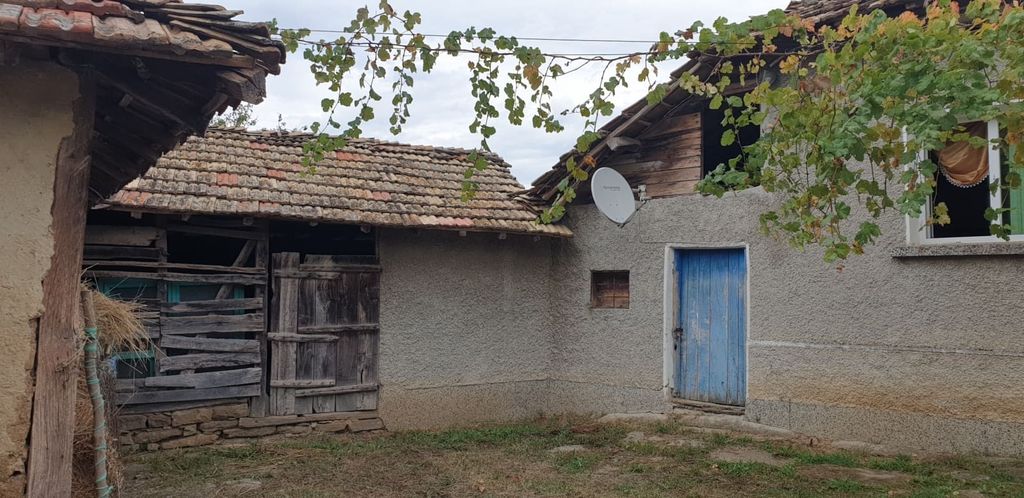Property photo 2 of 56 Corner Of A Rural House With Blue Door And Adjacent Wooden Outbuilding Under Tiled Roofs With Grapevine Overhead