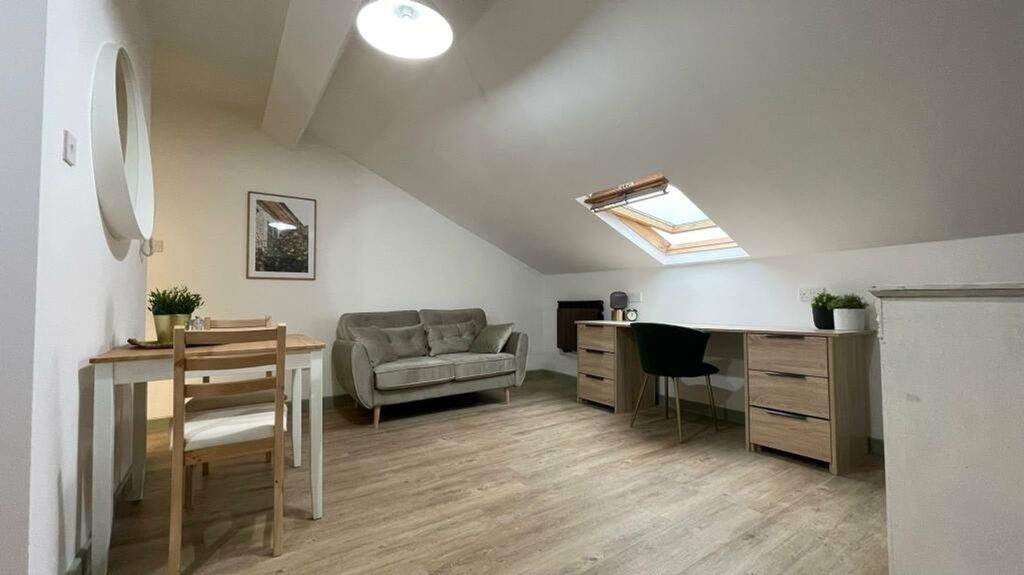 Property photo 3 of 7 A Spacious And Stylish Living Room With Ample Natu...