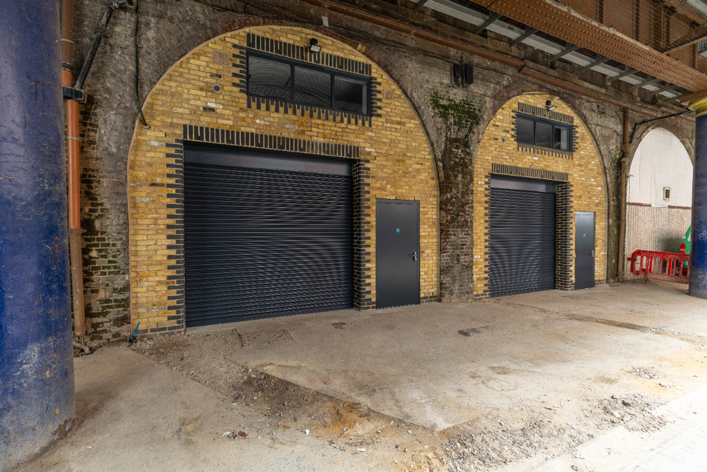 Property photo 2 of 2 The Front Of An Arch With A Closed Electric Roller Shutter Entrance Big Enough For Vehicle Access, And Separate Pedestrian Door.