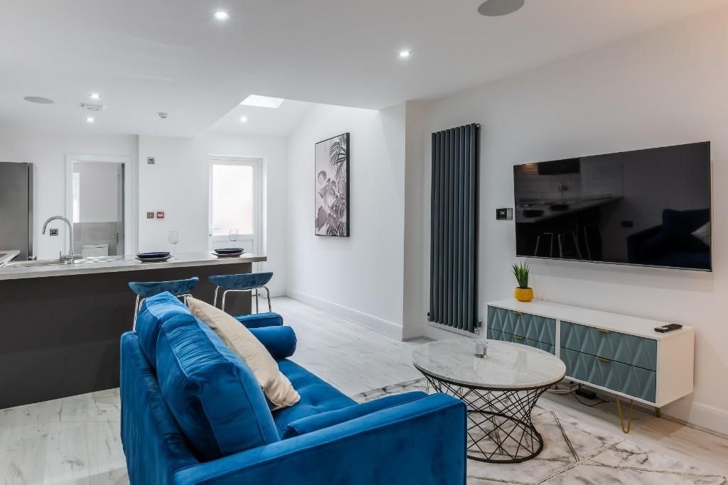 Property photo 3 of 10 A Modern And Spacious Living Room Featuring Comfor...