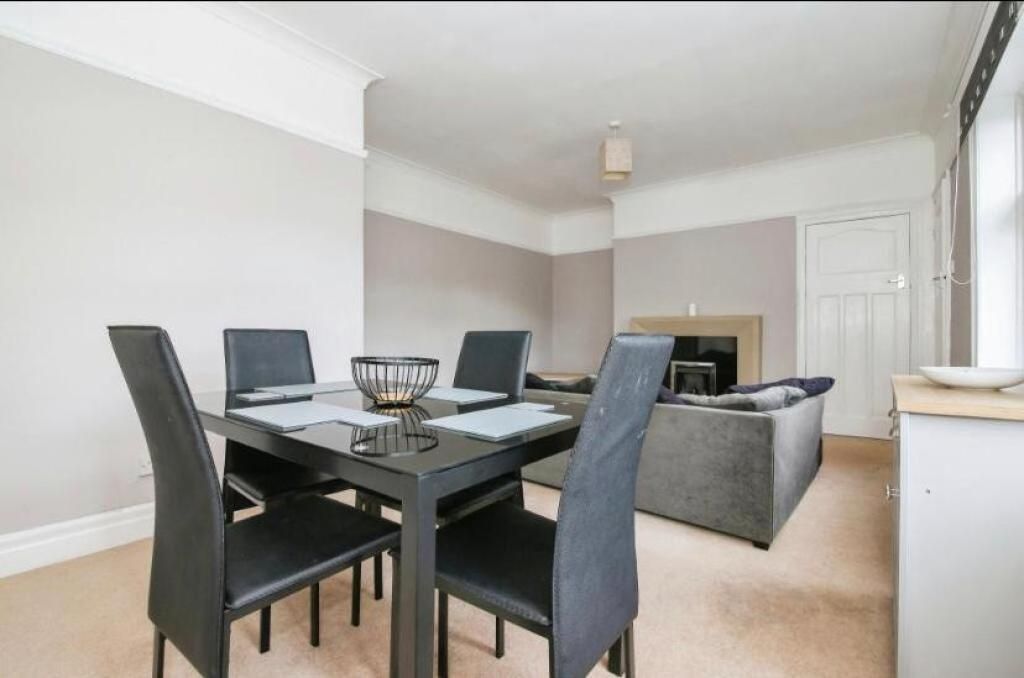 Property photo 1 of 10 Spacious Living Room Featuring A Modern Dining Set...