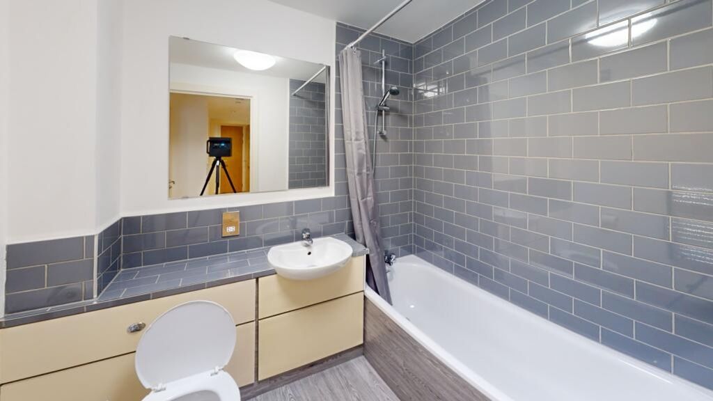Property photo 1 of 11 A Modern And Clean Bathroom Featuring Stylish Grey...