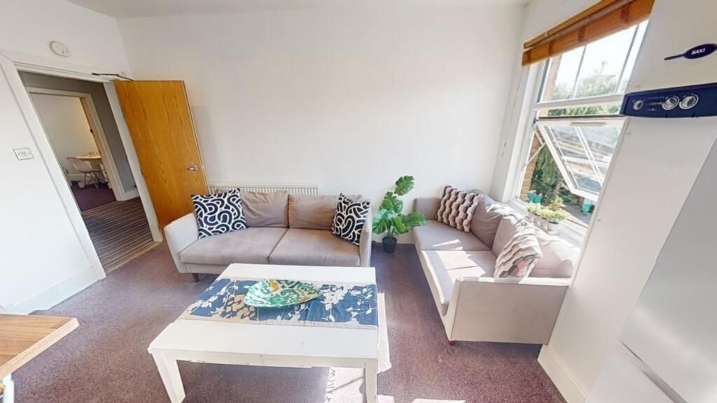 Property photo 2 of 11 Bright And Welcoming Living Room Featuring Two Com...