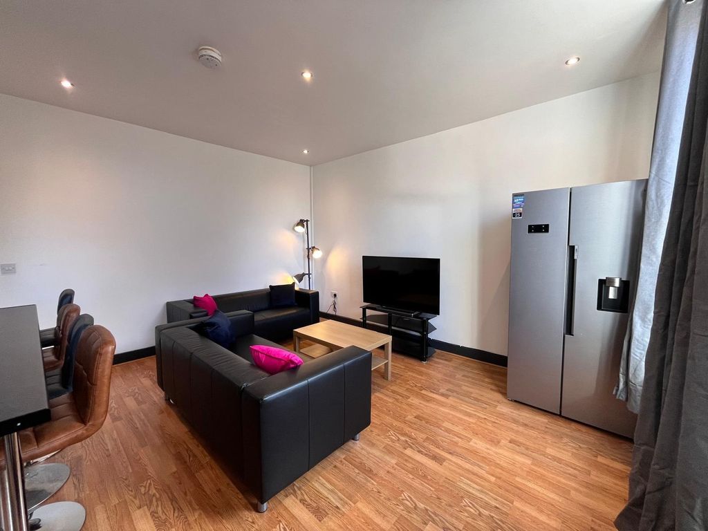 Property photo 3 of 11 A Modern Living Room Featuring Comfortable Black S...