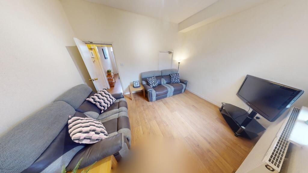 Property photo 1 of 7 A Bright And Welcoming Living Room Featuring Moder...