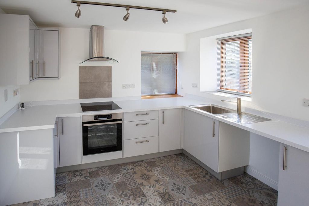 Property photo 3 of 13 A Modern And Bright Kitchen Featuring White Cabine...