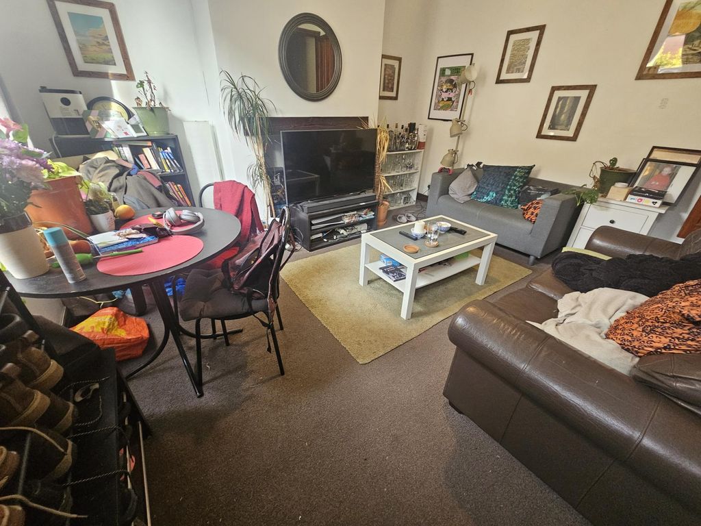 Property photo 3 of 7 A Cozy And Inviting Living Room Featuring Comforta...