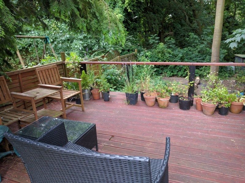 Property photo 3 of 5 A Charming Garden Deck Area Featuring Comfortable ...