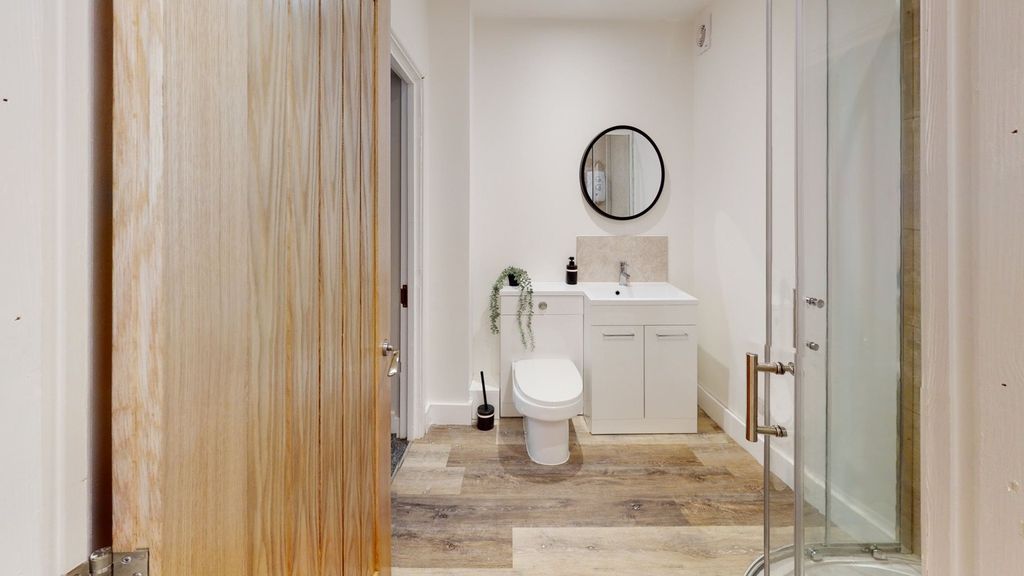 Property photo 1 of 12 A Modern And Clean Bathroom Featuring Stylish Fixt...