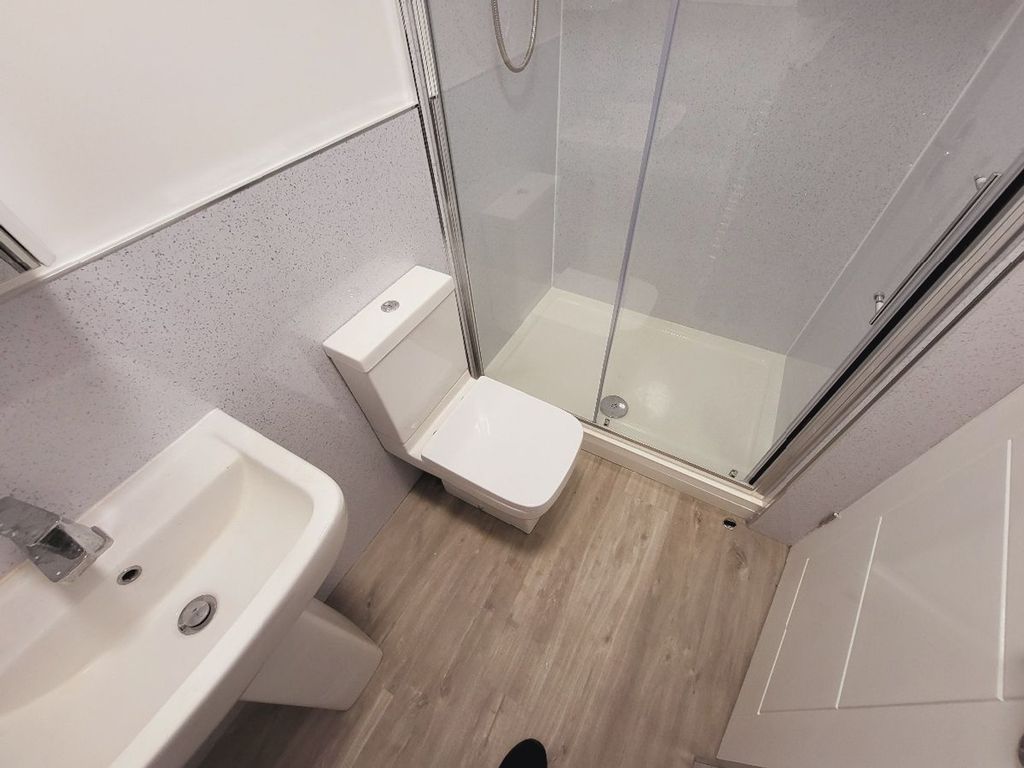 Property photo 3 of 15 A Modern Bathroom Featuring A Sleek Shower And Con...