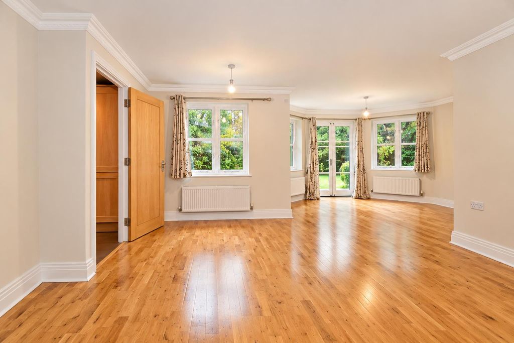 Property photo 2 of 14 Sunlit Empty Living Room With Bay Windows.Png