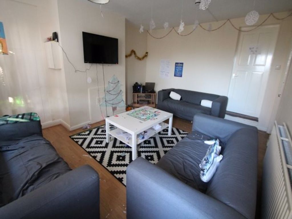 Property photo 1 of 8 A Spacious And Well-Lit Living Room Featuring Comf...