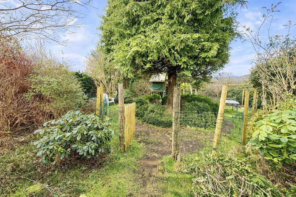Property photo 2 of 24 Rustic Garden Pathway With Lush Greenery.Png