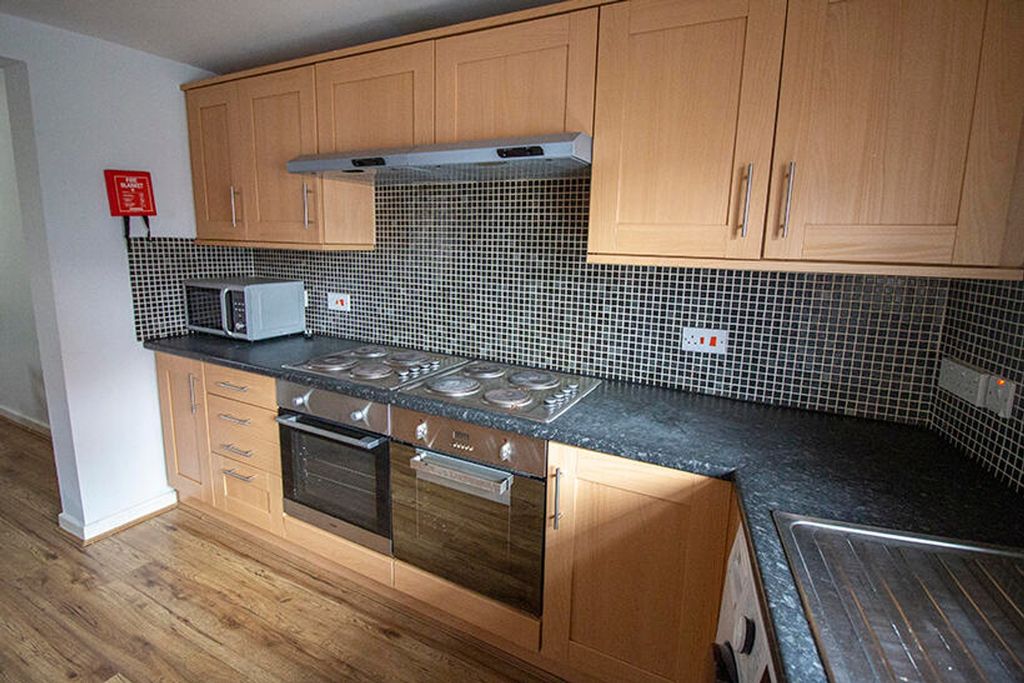 Property photo 2 of 5 This Modern Kitchen Features Ample Storage With Sl...