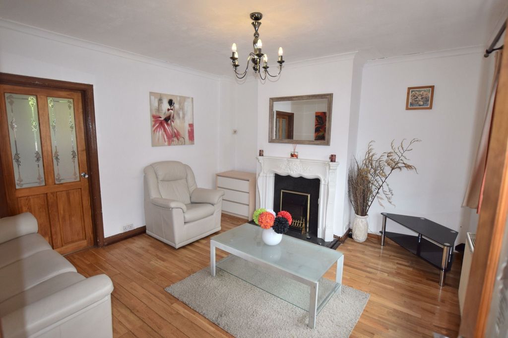 Property photo 1 of 7 A Cozy Living Room Featuring Light-Colored Leather...
