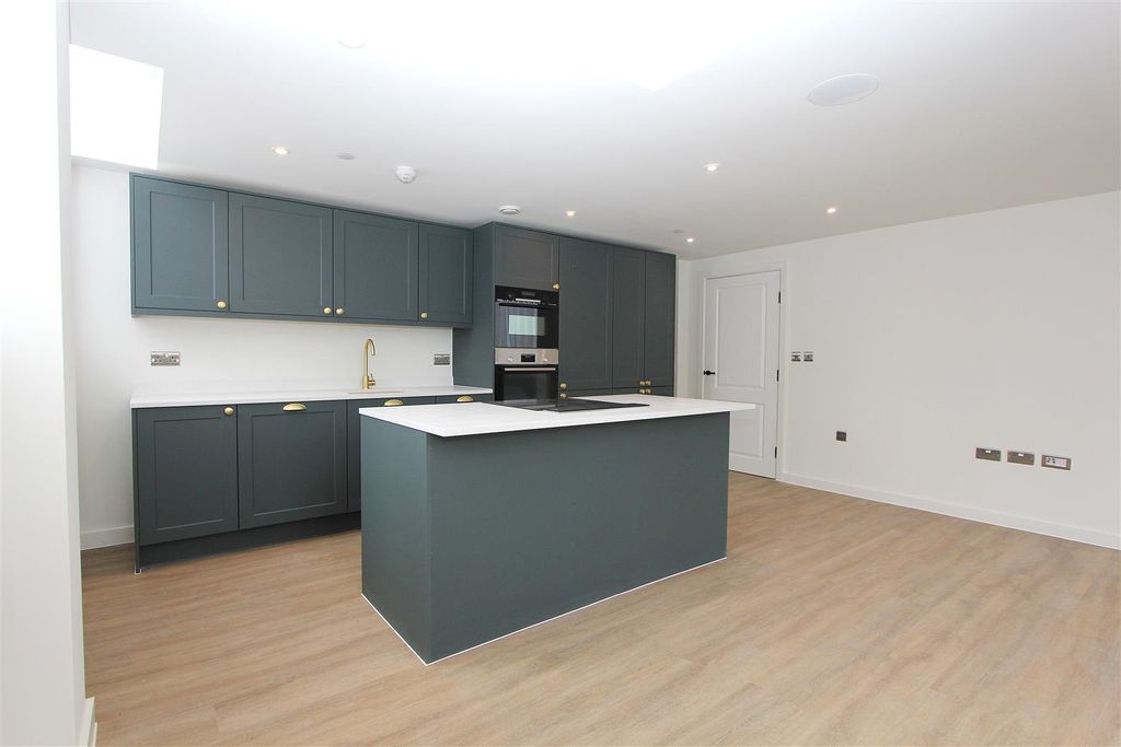 Property photo 3 of 13 Modern Kitchen With Stylish Island And Cabinetry...