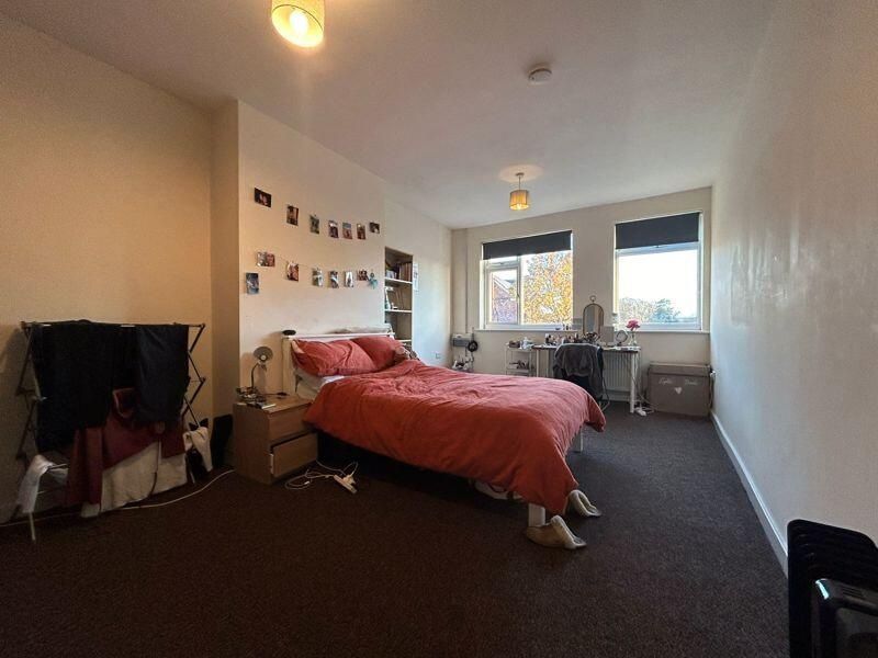 Property photo 3 of 10 A Cozy Bedroom Featuring A Neatly Made Bed, With N...